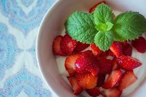 strawberry with sour cream and mint leaf