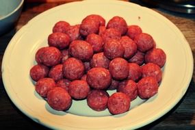 raw meatballs on a white plate