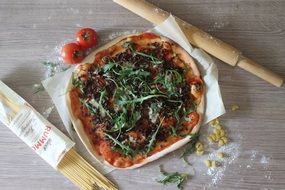 italian pizza, pasta and wooden rolling pin