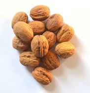 dried wallnuts on white surface