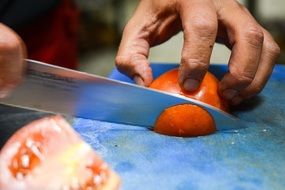 chef cutting tomatoes
