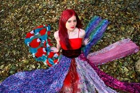 Girl in colorful dress forest leaves view