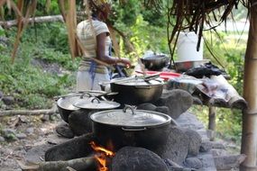 woman Cooking on Fire at River, Jamaica