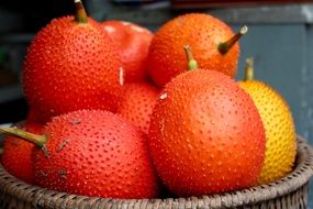 exotic orange fruits in a wicker bowl