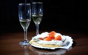 dessert with strawberries and two glasses of champagne