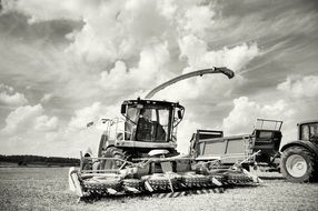 black and white photo of a harvester in a field