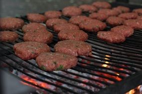 Hamburger meat with vegetables on the grill