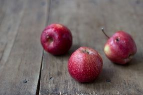 Red apples on the wooden table