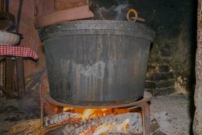 a cauldron stands on a wood stove