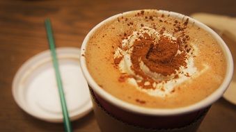 a glass of hot chocolate with straw