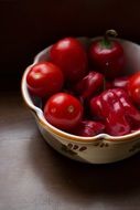 tomatoes and red pepper in a ceramic bowl