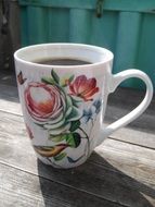 painted coffee cup on wooden table