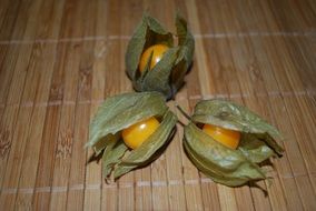 Three opened yellow healthy tasty physalis fruits