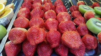 big ripe strawberries and kiwi at the buffet table