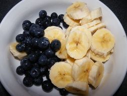 blueberries and banana on a white plate