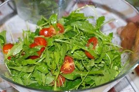 green salad with tomatoes in a bowl