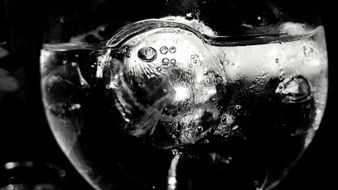 bubbles and ice in a glass in black and white background