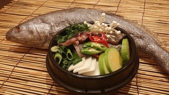 Croaker fish and colorful vegetables in bowl