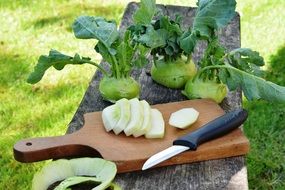 Kohlrabi cabbage sliced on a wooden board