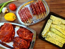 marinated meat for barbecue with colorful vegetables on the surface