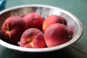 peaches in a tin bowl