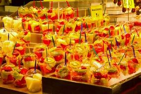 colorful cut Fruits in containers at market