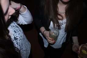 Girls are drinking alcohol on the party
