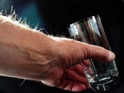 empty glass in hairy hand