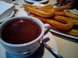 Churros with hot chocolate in winter