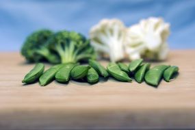 green peas in pods, broccoli and cauliflower