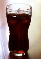 refreshing drink with cola and ice cubes