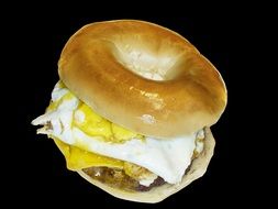 Round bagel with the egg inside for the breakfast