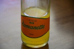 orange soft drink in a glass bottle romanette