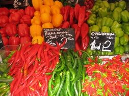 red and green long peppers on the market