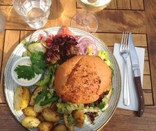 Burger with potatoes and salad