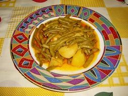 green beans and boiled potatoes on a beautiful plate