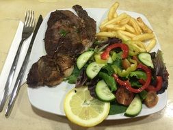 meat dish with potatoes and salad