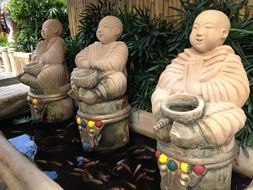 Buddha statues in a pond at the entrance to a restaurant in the Philippines