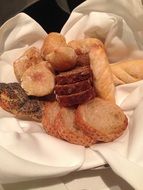 variety of bread on a white cloth