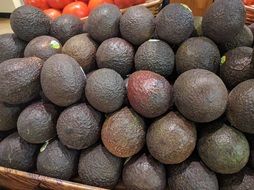 Black avocados in the market