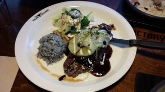 steak with vegetables on a plate in a restaurant