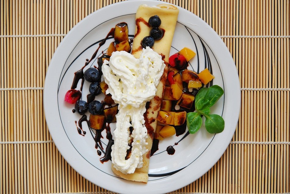 Sweet pancake with different fruits and berries,cream and chocolate sauce