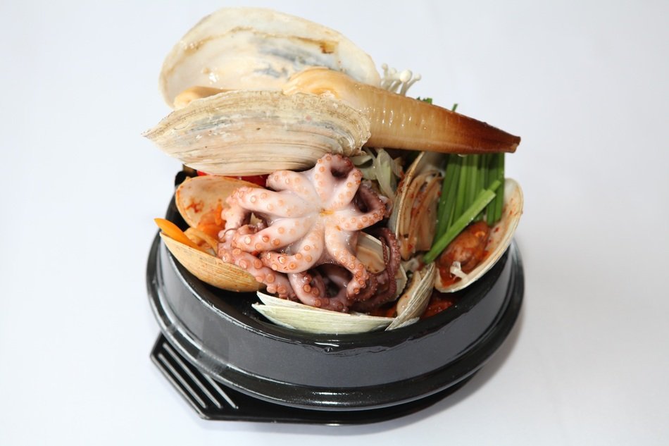 korean dish with seafood on a black plate