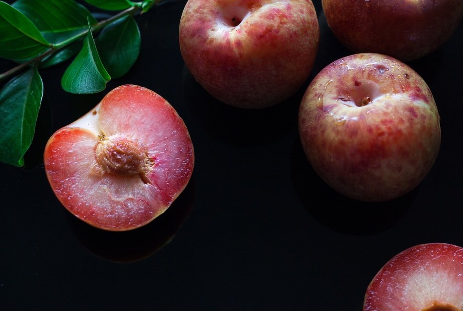 half of red Plum on black