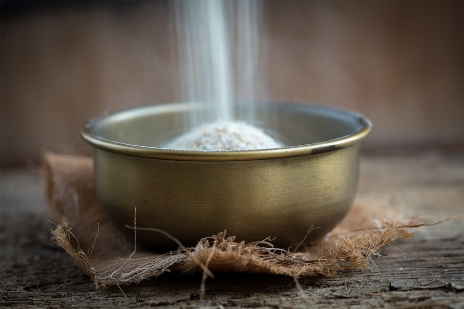 filling bowl of wheat grains
