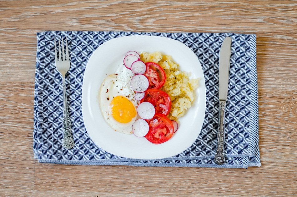 fried eggs with vegetables for breakfast