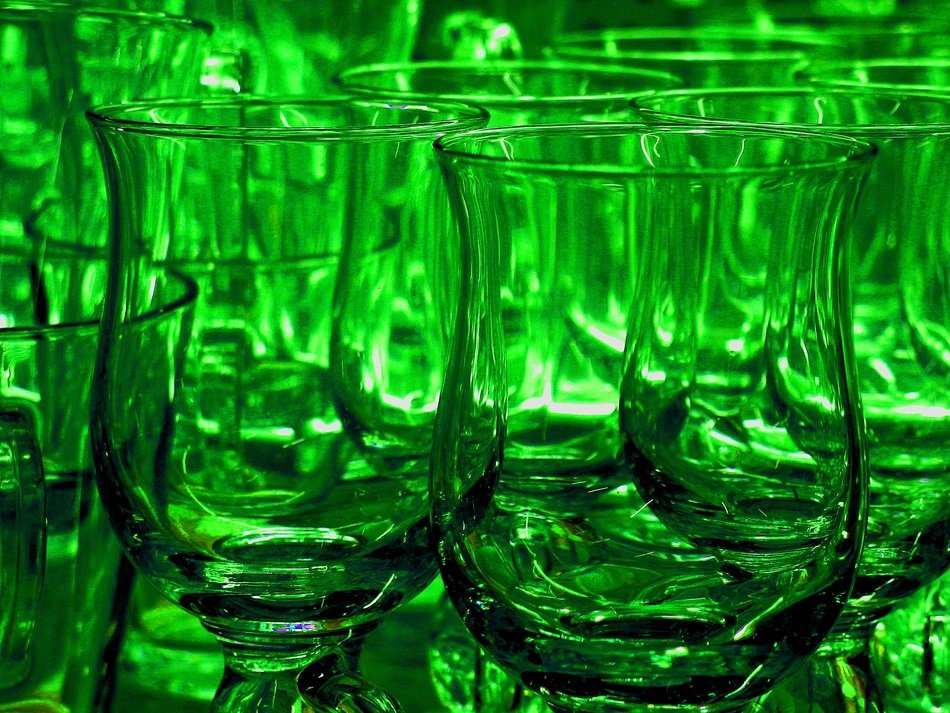 glass cups in green light
