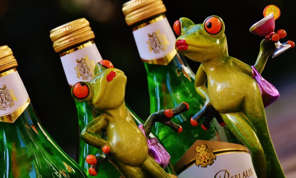 shapes of green cheerful frogs near the bottles