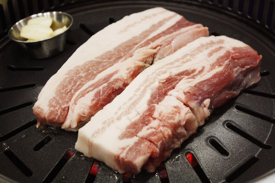 raw bacon on grill
