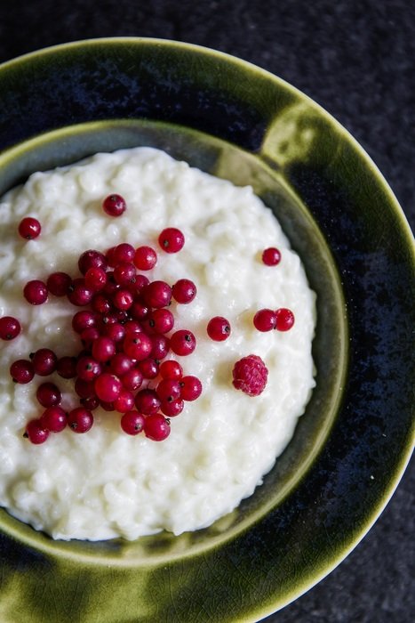 rice pudding with red berries on top